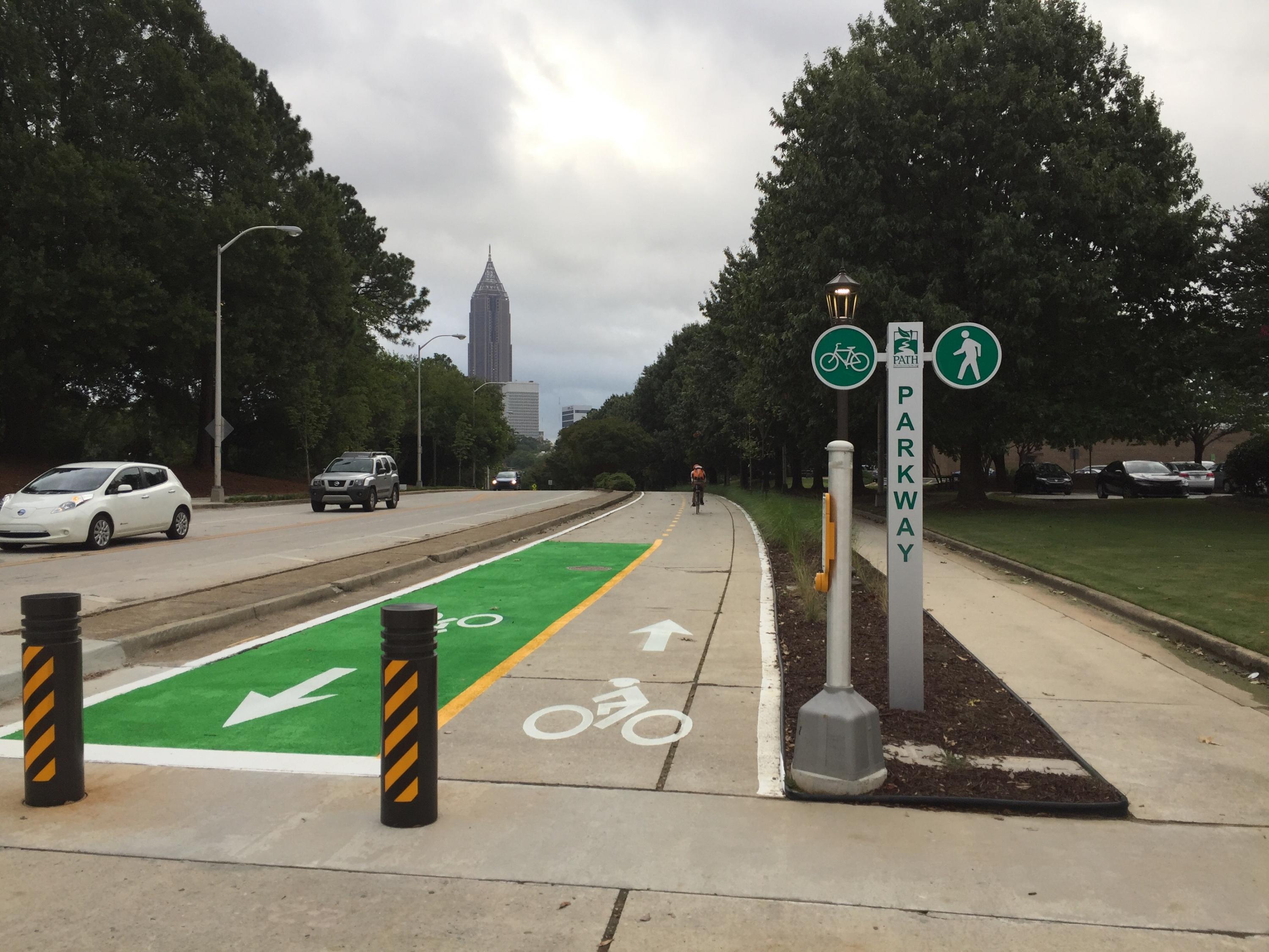 A cyclist rides south on the PATH Parkway near the intersection of Means Street