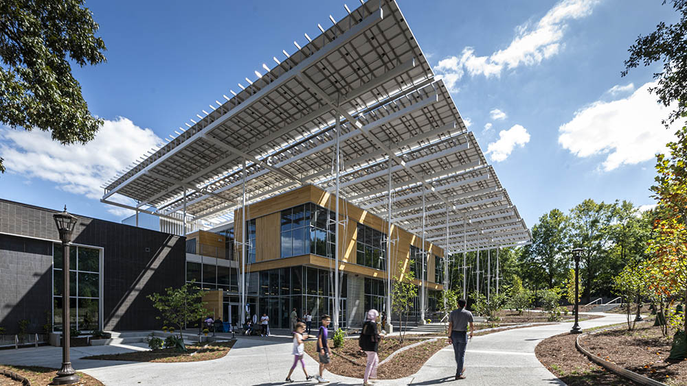 The Kendeda Building for Innovative Sustainable Design features a large "front porch" shaded by some of the hundreds of solar panels that generate electricity for the building. (Photo: Justin Chan Photography) The Kendeda Building for Innovative Sustainable Design features a large "front porch" shaded by some of the hundreds of solar panels that generate electricity for the building. (Photo: Justin Chan Photography)